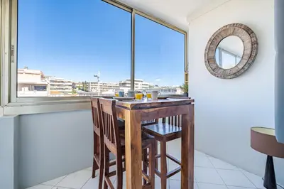 a table in a room with a window at Appartement à 100m de la plage, climatisé in Cagnes-sur-Mer