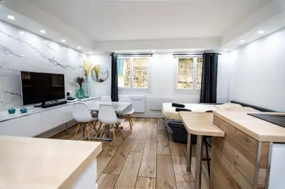 a room with two beds and a kitchen and a living room at Bel appartement - Nice centre in Nice