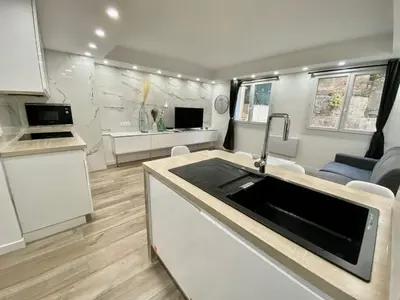 an rv kitchen with a sink and a microwave at Bel appartement - Nice centre in Nice