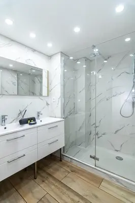 a white bathroom with a shower and a sink at Bel appartement - Nice centre in Nice