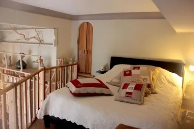 a bedroom with a bed with pillows on it at Charming apartment in Beaulieu sur Mer in Beaulieu-sur-Mer