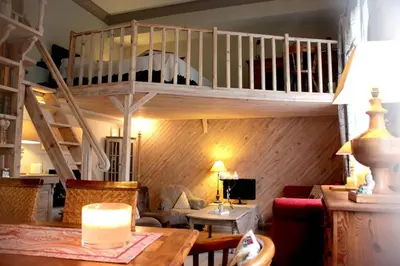 a living room with a loft bed and a couch at Charming apartment in Beaulieu sur Mer in Beaulieu-sur-Mer