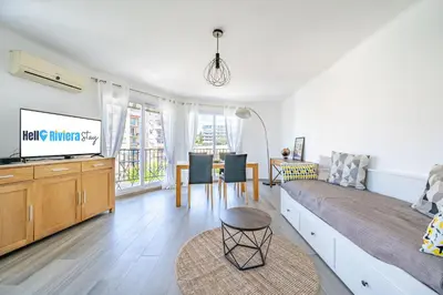 a bedroom with a bed and a tv and a table at Confortable 2 pièces 54 m2 proche de la mer in Nice