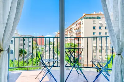 a balcony with a view of a city at Confortable 2 pièces 54 m2 proche de la mer in Nice