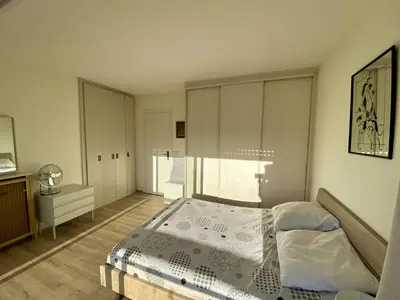 a bedroom with a bed and a large window at 2P Cagnes Sur Mer- Proximité Plage, Parking in Cagnes-sur-Mer