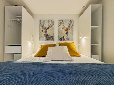 a bedroom with a bed with two deer paintings on the wall at Old Town - 4 pers, AC in Nice