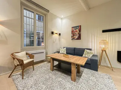 a living room with a blue couch and a table at Old Town - 4 pers, AC in Nice