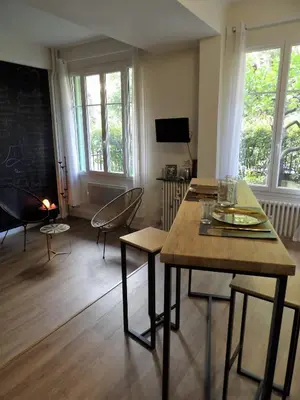 a living room with a table and chairs and a chalkboard at Studio japonisant in Nice