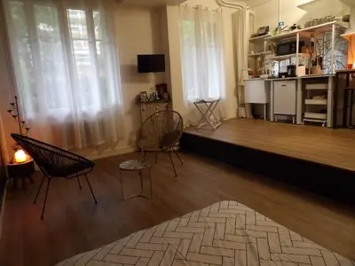 a living room with two chairs and a wooden floor at Studio japonisant in Nice