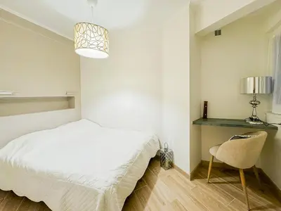 a bedroom with a bed and a desk and a chair at Gare Du Sud - Wifi, AC, balcon in Nice