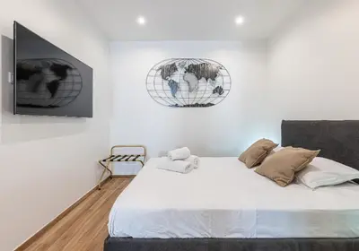 a bedroom with a large bed and two mirrors at LOFT à deux pas de la Mer avec terrasse n2 in Nice