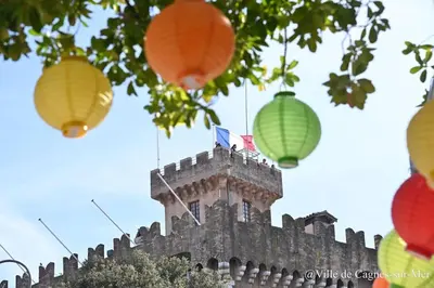 a group of colorful lanterns hanging from a building at Sea View Apartment - Private Parking, Swimming Pool, Air Conditioning in Cagnes-sur-Mer