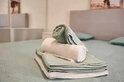 a pile of towels sitting on top of a bed at Moderne 2/3 Pièces près du Port in Nice