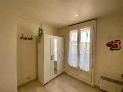 an empty room with a door and a window at STUDIO VERT FSHH in Nice