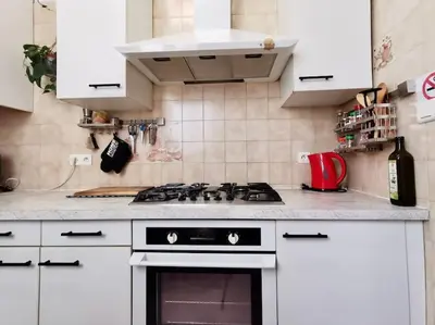 a kitchen with white cabinets and a stove top oven at Appartement Nice Bellecour in Nice
