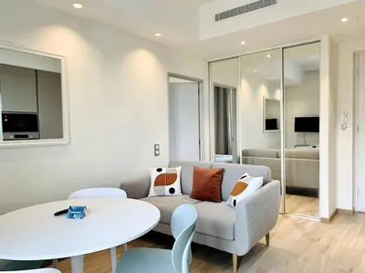 a living room with a couch and a table at Bright, newly renovated apartment in Nice