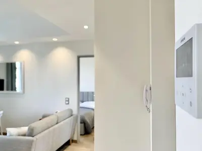 a living room with a couch and a television at Bright, newly renovated apartment in Nice