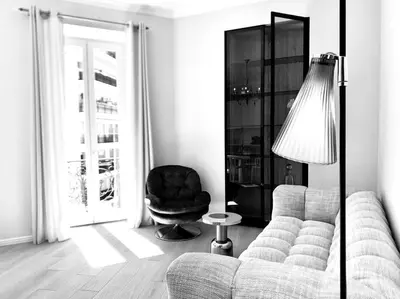 a living room with a couch and a chair at Luxuriously furnished bright newly renovated oasis in Nice