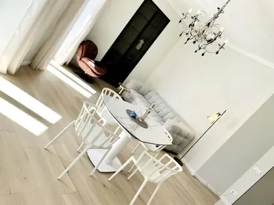 a living room with a table and chairs and a couch at Luxuriously furnished bright newly renovated oasis in Nice