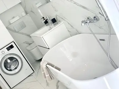 a white bathroom with a toilet and a sink at Luxuriously furnished bright newly renovated oasis in Nice