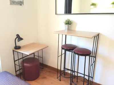 a bar with two stools and a mirror at Hôtel du Petit Louvre in Nice