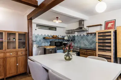 a kitchen with a white table and chairs at Chic Old Town Apartment in Nice