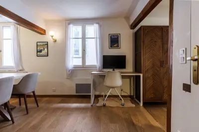a room with a desk with a computer and a chair at Chic Old Town Apartment in Nice