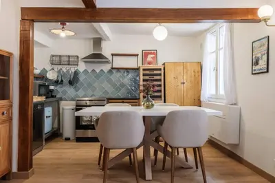 a kitchen with a white table and chairs at Chic Old Town Apartment in Nice