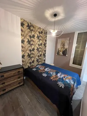 a bedroom with a bed and a dresser at Port de Nice belle petite pépite in Nice