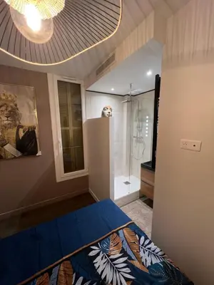 a bedroom with a blue bed and a shower at Port de Nice belle petite pépite in Nice