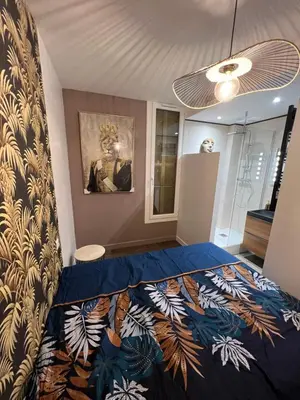 a bedroom with a bed with a blue comforter at Port de Nice belle petite pépite in Nice