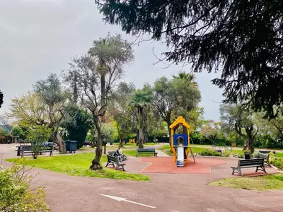 a park with benches and a playground with a play structure at Grand 3 pièces avec parking à Nice Cimiez in Nice