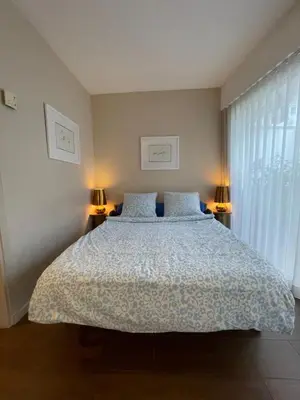 a bedroom with a large bed with two lamps at Royal lux promenade des anglais in Nice