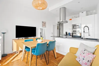 a kitchen and living room with a table and chairs at Terrasse des Oliviers in Nice