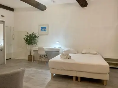a bedroom with a bed with a teddy bear on it at ApartHotel Riviera - Cocon de Gilly - Old Town Promenade des Anglais in Nice