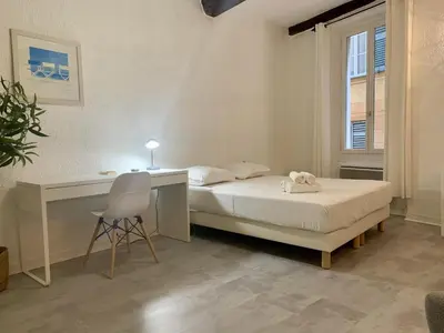 a bedroom with a bed and a desk and a chair at ApartHotel Riviera - Cocon de Gilly - Old Town Promenade des Anglais in Nice