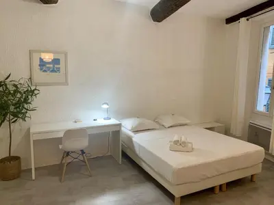 a bedroom with a bed and a desk and a chair at ApartHotel Riviera - Cocon de Gilly - Old Town Promenade des Anglais in Nice
