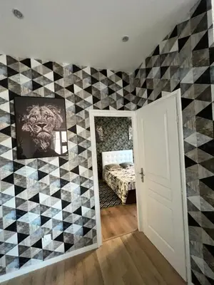 a bedroom with a checkered wall at Joyau rare port de Nice in Nice
