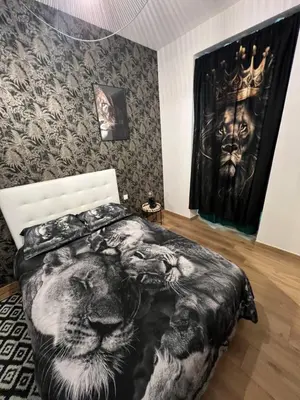 a bedroom with a bed with a lion and a wall at Joyau rare port de Nice in Nice