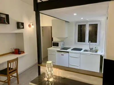 a kitchen with white cabinets and a sink and a microwave at ApartHotel Riviera - DUPLEX DE JULES - Large Studio with A C - Old Town Promenade des An in Nice