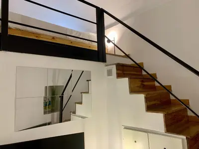 a staircase in a house with a glass window at ApartHotel Riviera - DUPLEX DE JULES - Large Studio with A C - Old Town Promenade des An in Nice