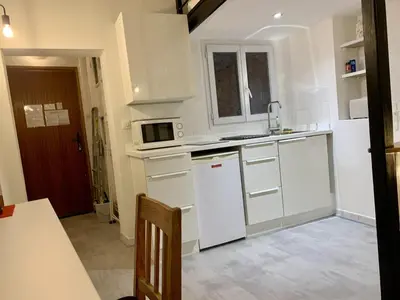 a kitchen with white cabinets and a microwave at ApartHotel Riviera - DUPLEX DE JULES - Large Studio with A C - Old Town Promenade des An in Nice