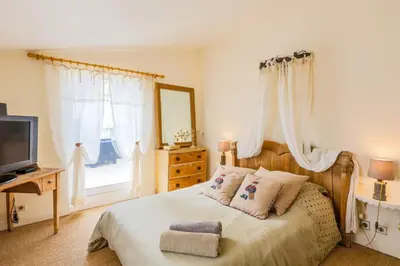 a bedroom with a bed with a mirror and a television at LOU MAS SOUBRAN VI2083 by RIVIERA HOLIDAY HOMES in Nice