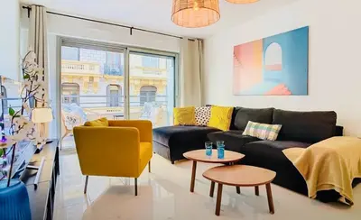 a living room with a couch and a table at Appartement Nice Palais de la Méditerranée in Nice