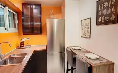 a kitchen with a stainless steel refrigerator and a sink at Appartement Nice Palais de la Méditerranée in Nice