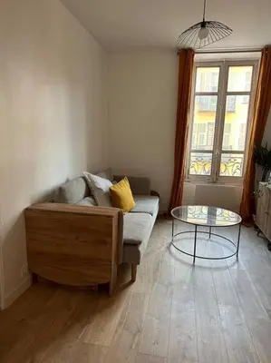 a living room with a couch and a glass table at Cosy Nice appartement in Nice