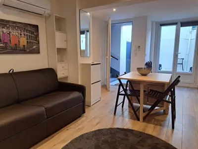 a living room with a couch and a table at Studio avec Terrasse à 5 minutes de la plage N6 in Saint-Laurent-du-Var