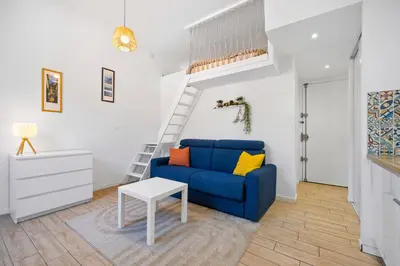 a living room with a blue couch and a table at Nice Renting - GAUTIER - Elegance Height Port & Castle Nice in Nice