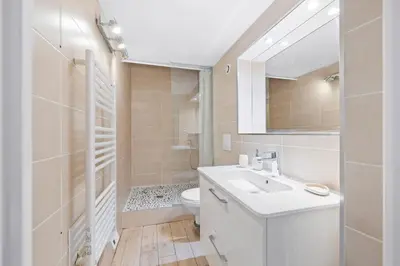 a white bathroom with a sink and a toilet at Nice Renting - GAUTIER - Elegance Height Port & Castle Nice in Nice