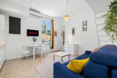 a living room with a blue couch and a table at Nice Renting - GAUTIER - Elegance Height Port & Castle Nice in Nice